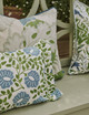 Close-up of Punch Paisley pleated cushion in green from Christopher Farr Cloth summer campaign, styled with Carnival Green and La Jungle Green cushions for a layered, vibrant look.